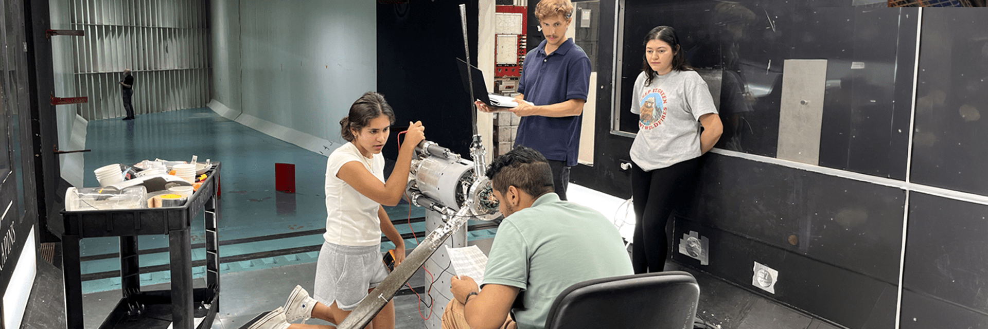Students working on the tilt rotor rig in the wind tunnel